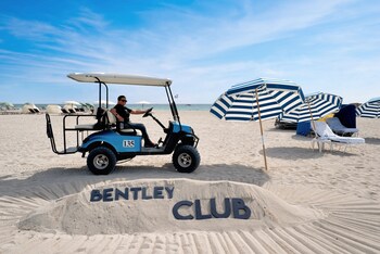 On the beach, white sand, beach cabanas, beach umbrellas