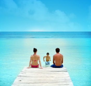 On the beach, white sand, sun loungers, beach towels